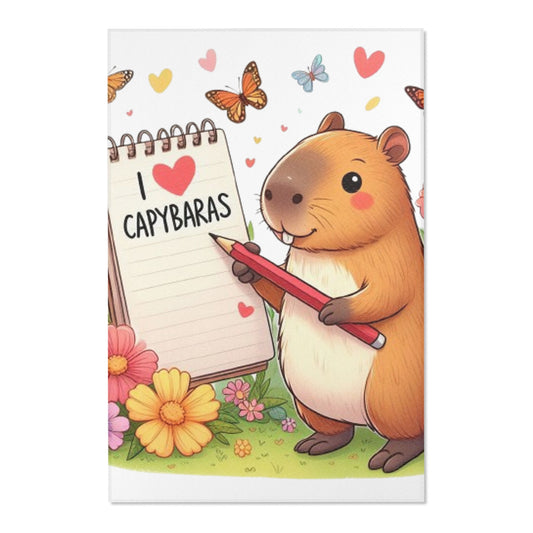 Capibara sosteniendo un lápiz y una libreta con I Love Capybaras, lindo roedor rodeado de flores y mariposas, alfombras